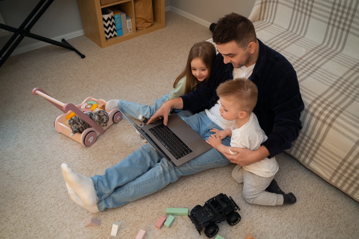 High angle father working with kids at home 