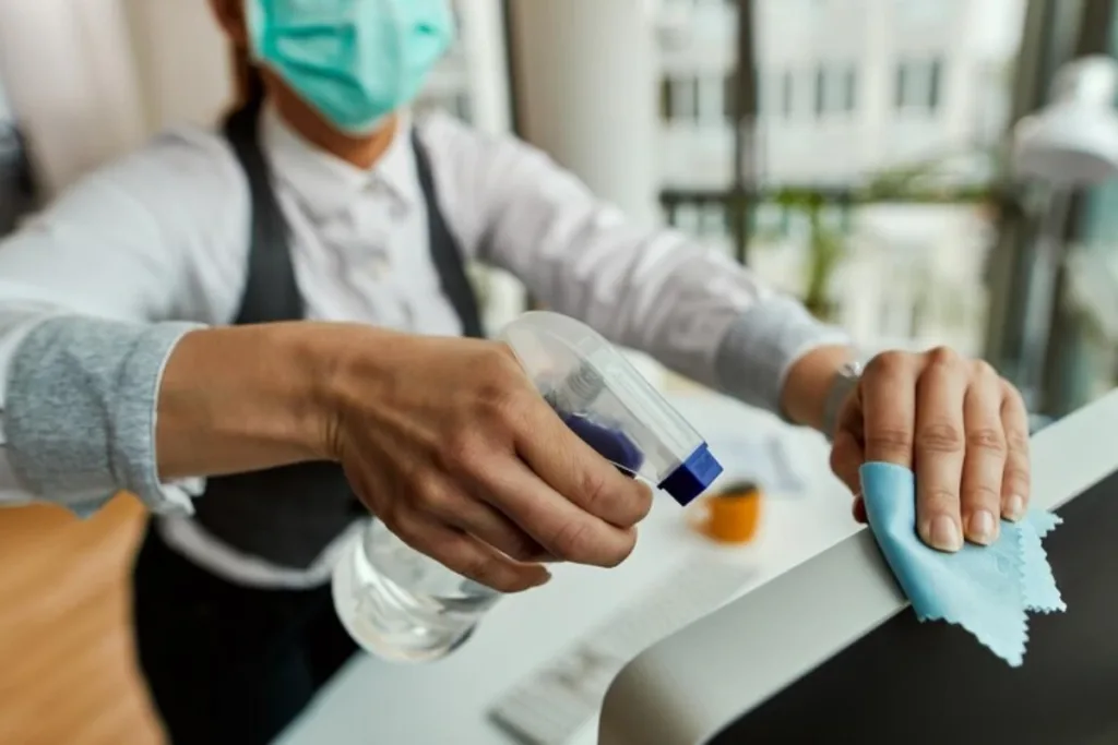 woman cleaning her computer while working