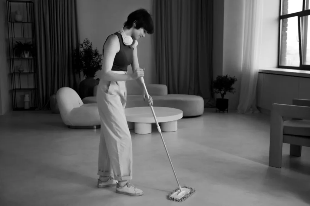 full shot woman mopping floor