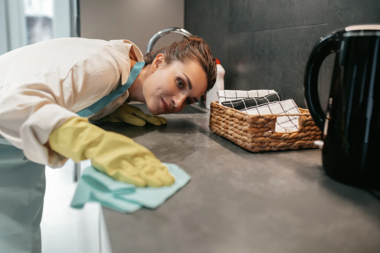 young-dark-haired-woman-cleaning-surfaces-kitchen Young dark-haired woman cleaning the surfaces in the kitchen