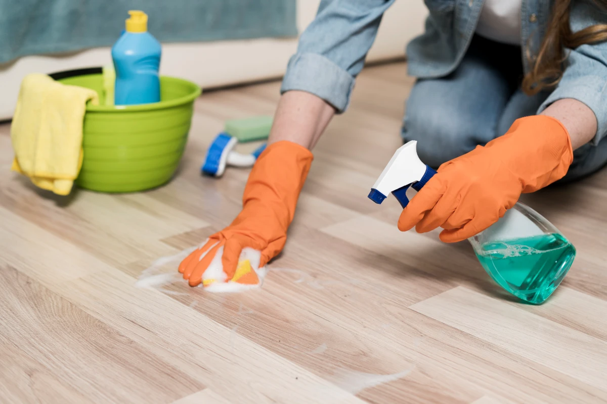 woman with rubber gloves cleaning floors in Baltimore