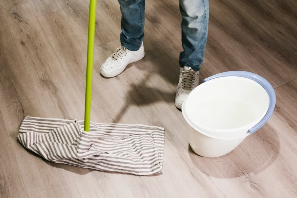 close up man mopping floor
