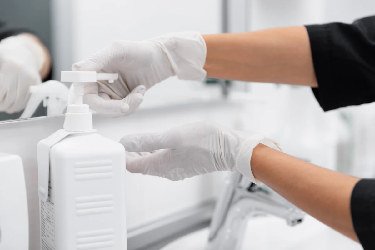 close up hands using disinfectant